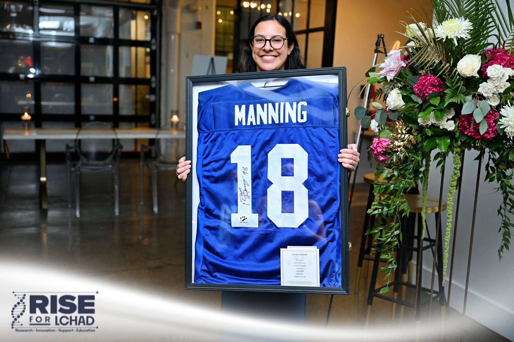 Supporter with a signed Peyton Manning jersey auction item