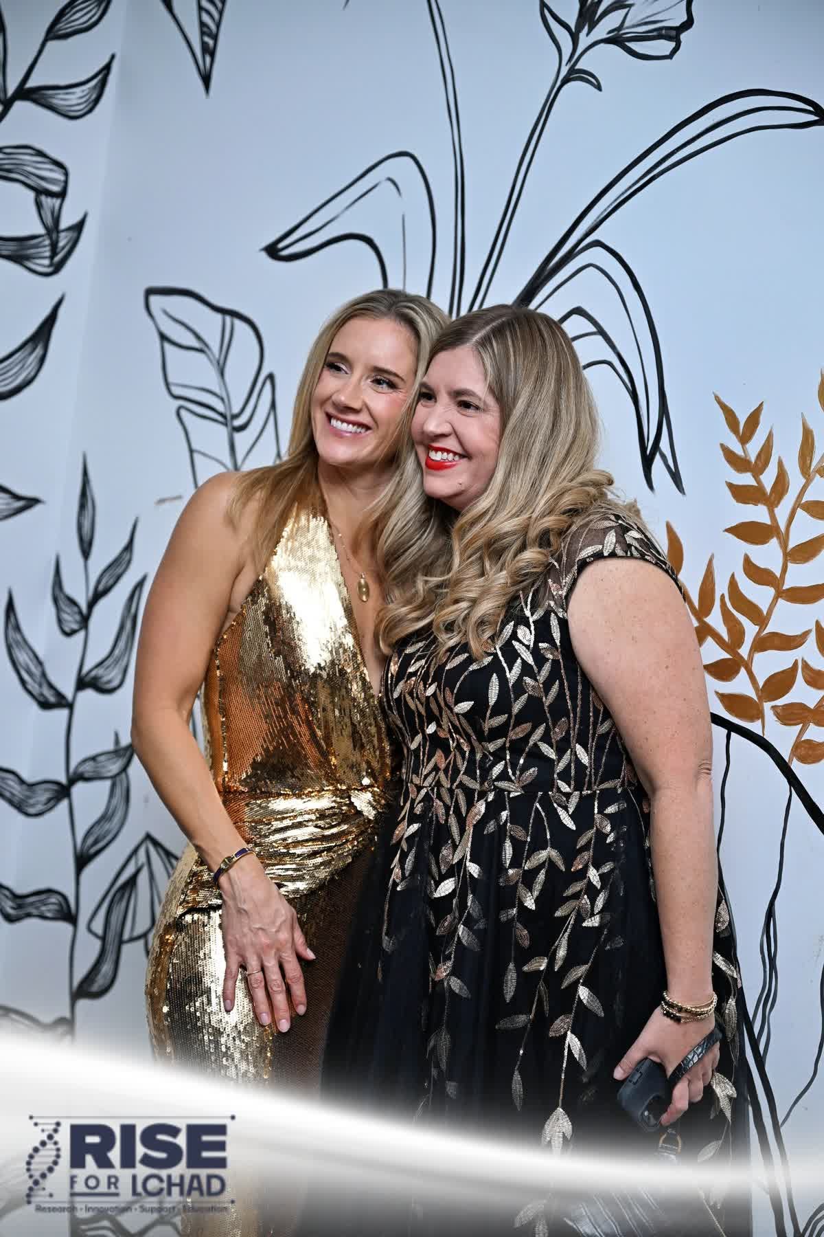 Guests posing in front of the mural at The Stutz
