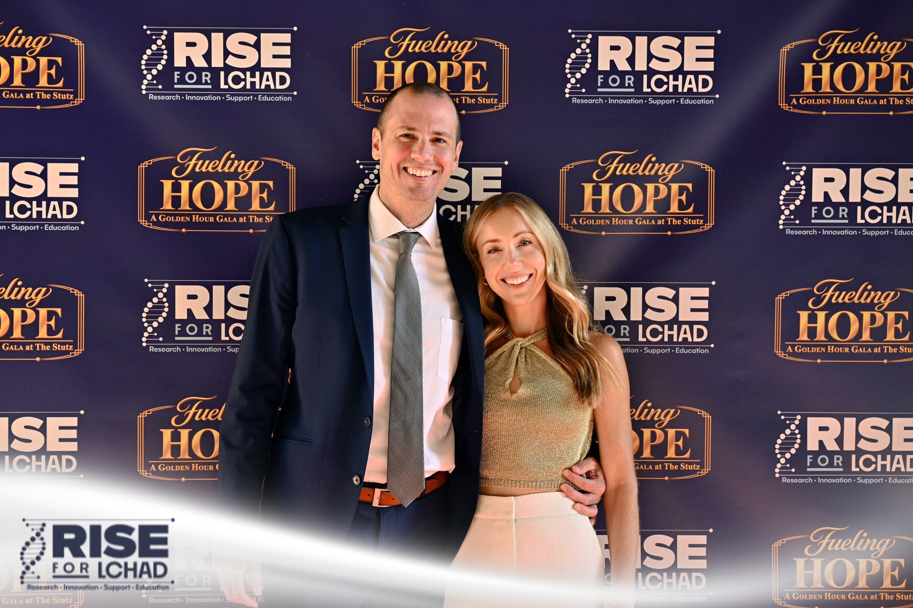 Couple posing on the red carpet at the Fueling Hope Gala